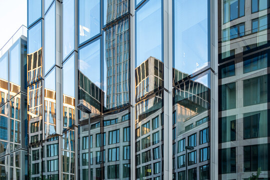 Modern glass facade in Frankfurt Germany with reflection on windows creating a bold pattern for urban architecture in the financial district background