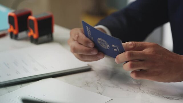 Customs officer stamps approved seal in North Korean passport, visa confirmation