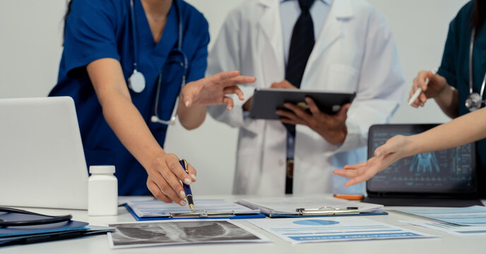 Medical team working on digital tablet healthcare doctor technology tablet using computer analyzed the results of medical reports at the hospital.