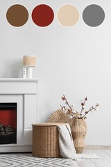 Naklejka premium Fireplace, wicker basket and vase with cotton flowers near white wall in interior of living room. Different color patterns