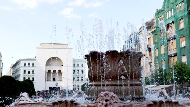 Large ornate stone fountain with jets spraying in a Timisoara square, Romania