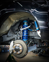 4x4 suspension upgrade installation in automotive workshop © Tino Nugroho
