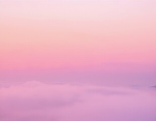 Fototapeta premium a pink sky with soft clouds drifting above distant, hazy mountains at sunset