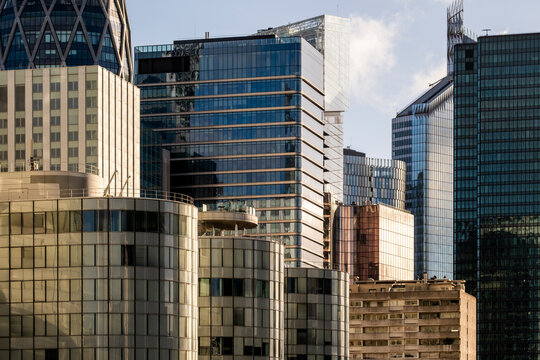 Glass skyscraper with strong facade architecture over modern business skyline at sunset in La Defense Paris France showing corporate office district atmosphere