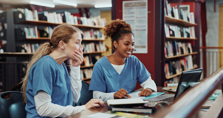 Fototapeta na wymiar Women, medical students and happy with laptop at library for test results, solution and project at campus. Girl, healthcare scholarship and computer with smile, discussion and feedback at university