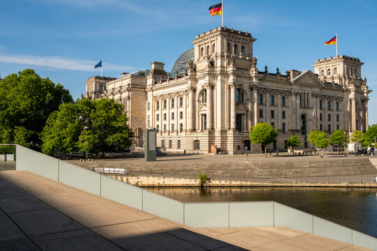 Panorama of Reichstag parliament and government architecture landmark along the Spree river in Berlin Germany with wide skyline perspective in daylight