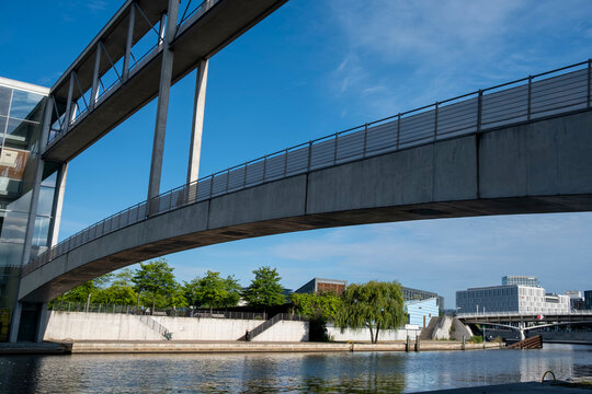 Steel modern bridge walkway for pedestrian crossing above the Spree river in Berlin Mitte Germany showing clean design lines and open sky