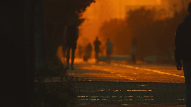 People walking at sunset with beautiful golden hour light