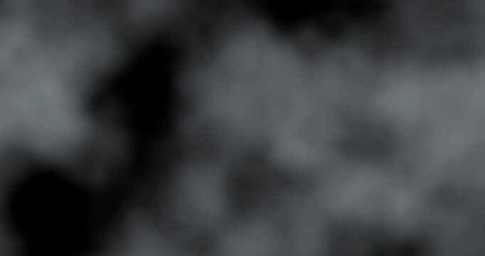 black and white smoke explosion slowly floating through space against black background