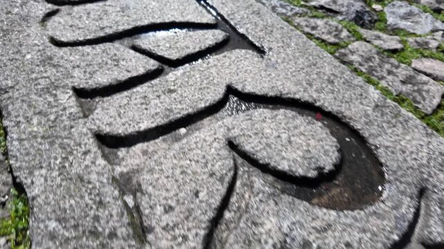 Guimaraes city monuments letters engraved on the cobblestone. Gimbal shot.
