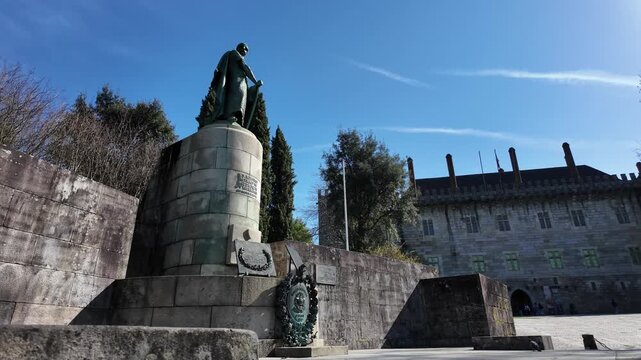 Guimaraes city monuments Dom Afonso Henriques statue on a sunny day. Gimbal shot with side movement.