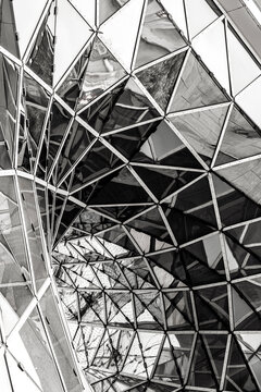 Abstract architecture structure with geometric glass and metal pattern in monochrome showing modern roof design and strong repeating lines