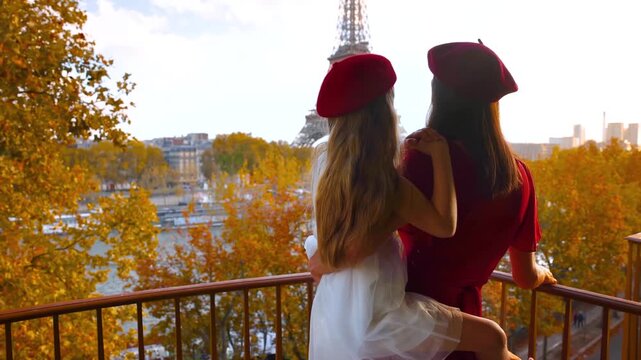 A mother and daughter enjoying the beautiful Eiffel Tower views in Paris, France, from their balcony