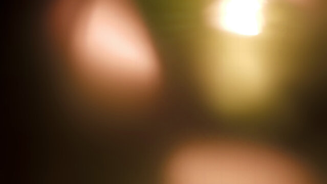 Abstract background featuring soft warm lens flare effects and subtle bokeh light leaks creating a beautiful vintage tone overlay ideal for design projects