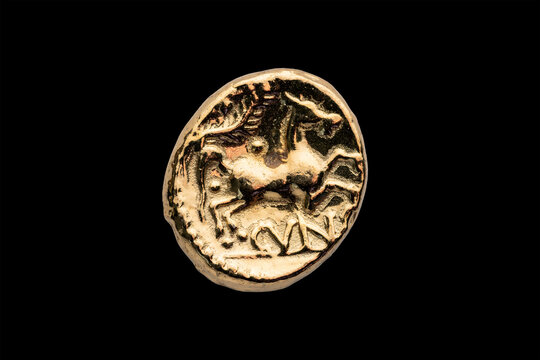 Gold Stater replica coin of Cunobelin AD 10-40 king of the ancient Briton tribes Catuvellauni and Trinovantes, reverse showing a horse cut out and isolated on a black background, stock photo image