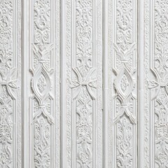 Ornate white wall paneling with vertical symmetry, intricate raised floral patterns