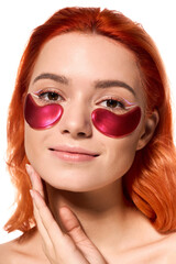 Fototapeta premium Stylish young woman enjoying skincare routine with vibrant orange hair and fashionable eye patches