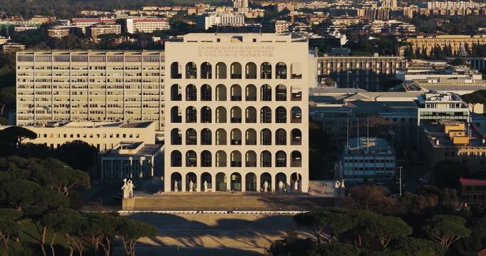 Aerial view of the Palazzo della Civilta Italiana, a striking symbol of rationalist architecture, towering over the landscape with its arches, Rome, Lazio, Italy.