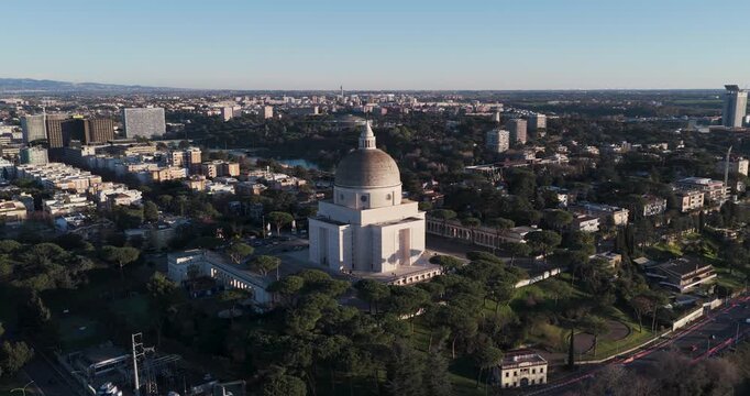 Aerial view of the Mausoleo Ossario Garibaldino contrasts with the cityscape and surrounding trees, creating a striking visual, Rome, Lazio, Italy.
