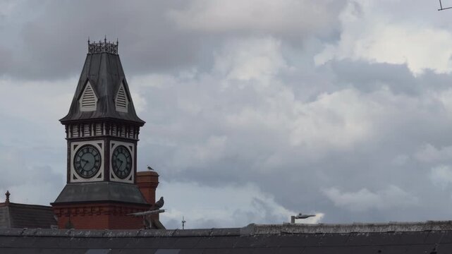 Clock tower with cloudy sky and negative space for text left aligned