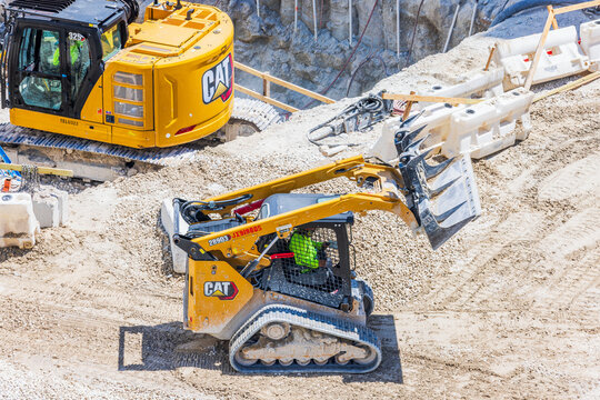 Top view of Caterpillar skid steer loader moving gravel at construction site heavy machinery industrial work. Miami Beach. USA. 