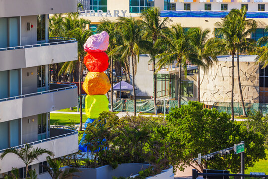 Beautiful view of Ugo Rondinone Miami Mountain colorful stacked rock sculpture in park on Collins Avenue with palm trees. Miami Beach. USA. 