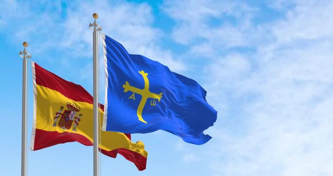 The Asturias flag waving with Spanish flag on a clear day