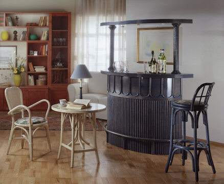 Single shot photo of a room with a rattan bar cabinet