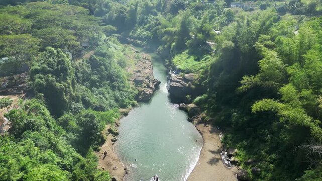 Drone view of Pantihan Falls basin pool surrounded by rocks and vibrant tropical forest at Maragondon Cavite Philippines