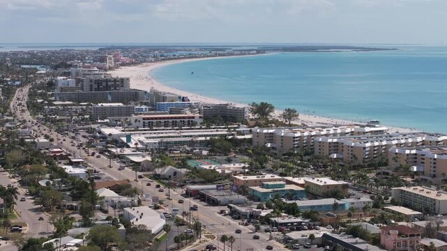 Aerial longshot vista of Gulf Boulevard on Saint Pete Beach facing south, showcasing beachfront hotels, resorts, white sand beach, and turquoise Gulf waters in Florida's premier beach destination.