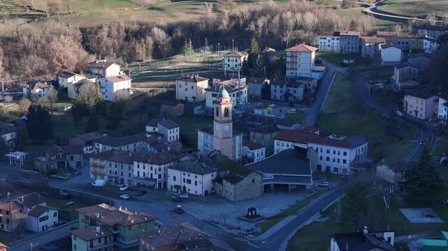 Aerial shot of Morfasso village with church, houses and rural landscape in Piacenza province, Emilia-Romagna region, northern Italy.