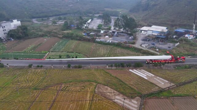 Travel Promo: Wind Turbine Transport on Misty Rural Road