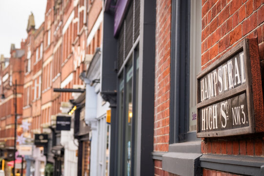 LONDON - 15 DECEMBER 2025: Hampstead High Street NW3 &ndash; Classic Street Sign on Brick Wall