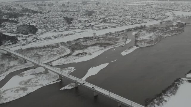Aerial Drone View of Hii River in Izumo Japan Covered with Snow &ndash; Winter Landscape