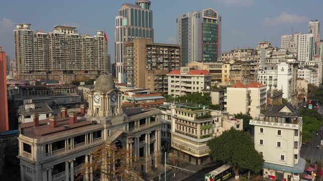 Flying over a variety of different historic and new buildings in Guangzhou, China