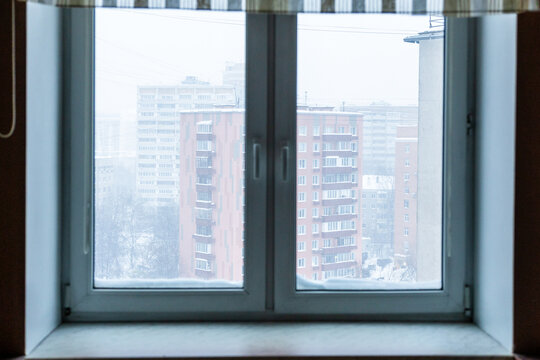 view through home window on apartment building