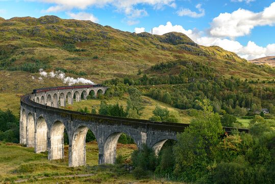 Glenfinnan Railway Viaduct Scotland passing train smoke Harry Potter train