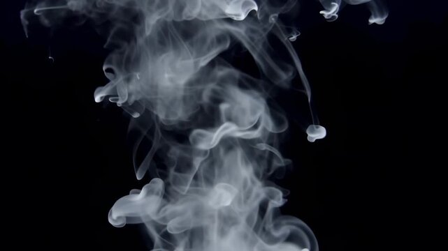 Ethereal white smoke or ink gracefully descending through a deep black void. The fluid, wispy tendrils swirl and bloom into delicate, cloud-like patterns, creating a hypnotic and abstract visual.