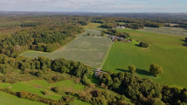 Rookesbury Park Wickham Hampshire high drone flight over the Bere Forest and beautiful countryside of the Rookesbury Park Estate on sunny Autumn day with leaves changing colour