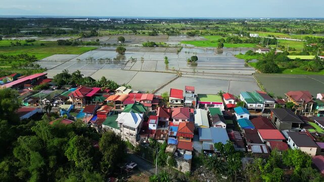 Daylight aerial view of Bucal Maragondon Cavite Philipines countryside showing rice fields, nearby houses, and highway road crossing the rural landscape.