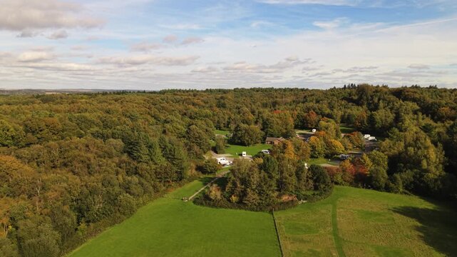 Rookesbury Park Wickham Hampshire reveal of Caravan and Motorhome Club campsite in wooded setting of the Bere Forest with Autumn trees beautiful sky in bright sunlight