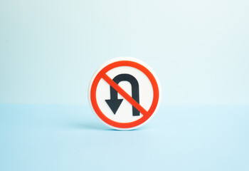 Forbidden left turn traffic sign. Concept of no turning back and irreversible decisions. The impossibility of retreat and changing the past, commitment and moving forward