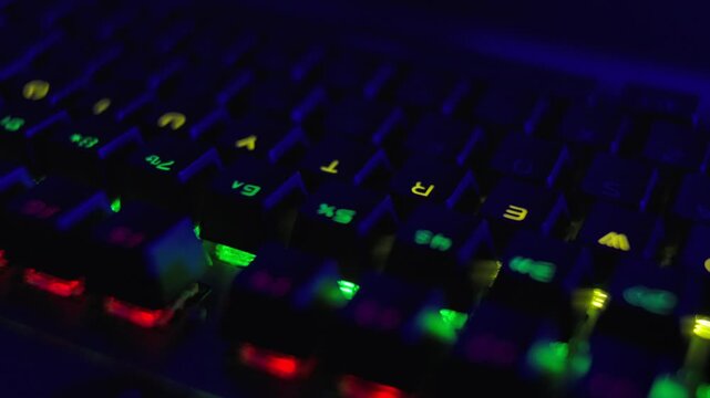 PC RGB Keyboard is Glowing Neon Colors. Modern Backlit Keyboard With Pulsating RGB Colour Light. Cyber Sport Illuminated Mechanical Gaming Keyboard. Gaming Keyboard With Rainbow of Colors Letters.