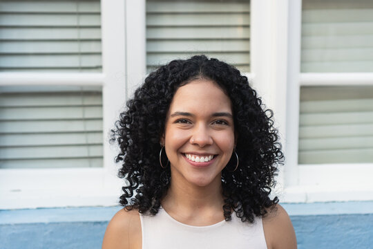 Young woman smiling with natural curly hair