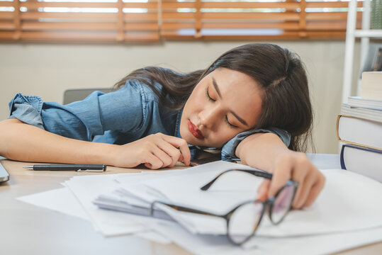 Person fall asleep on the desk have overwork night.