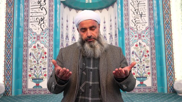 A Muslim sheikh praying in the mosque during Eid al-Fitr. Worship during the month of Ramadan. Concept of Islamic holidays.