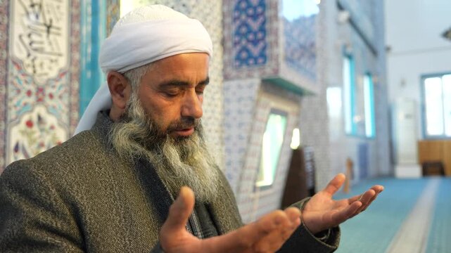 A Muslim sheikh praying in the mosque during Eid al-Fitr. Worship during the month of Ramadan. Concept of Islamic holidays.