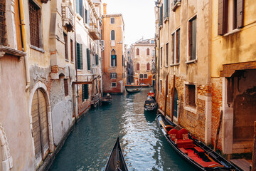 Venice canals with boats and buildings during a sunny day