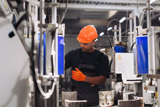 Employee working at window manufacturing factory machinery