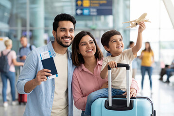 happy indian family walking with travelling bag